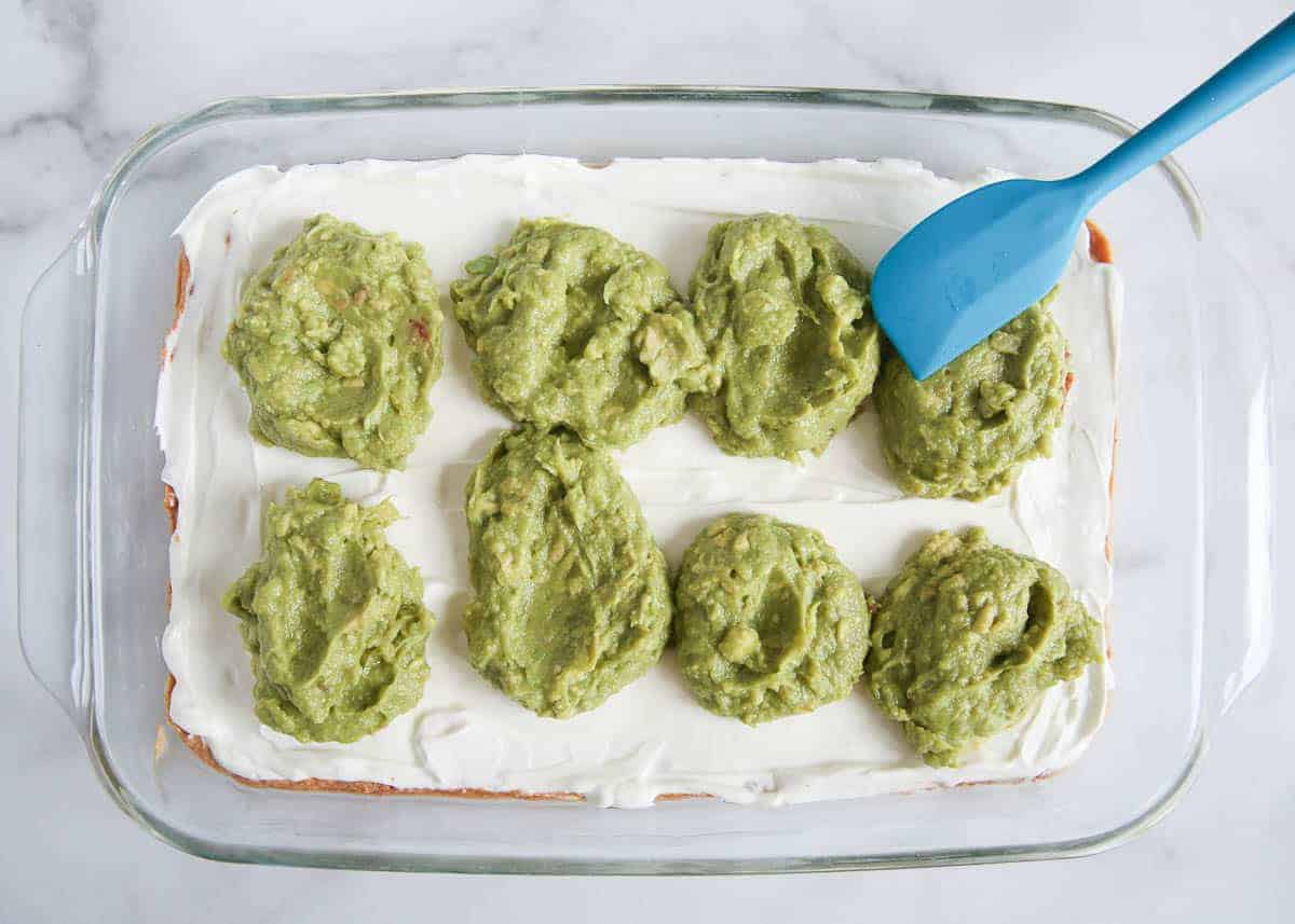 Cream cheese and guacamole layered over refried beans.