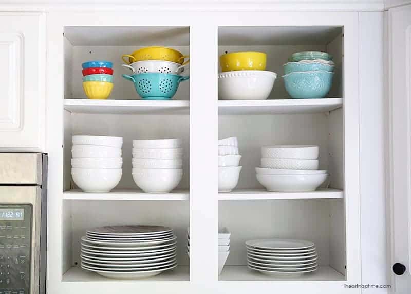 cabinets with bowls and plates inside 