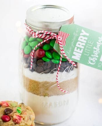 M&M cookie mix layered in a mason jar with a christmas tag