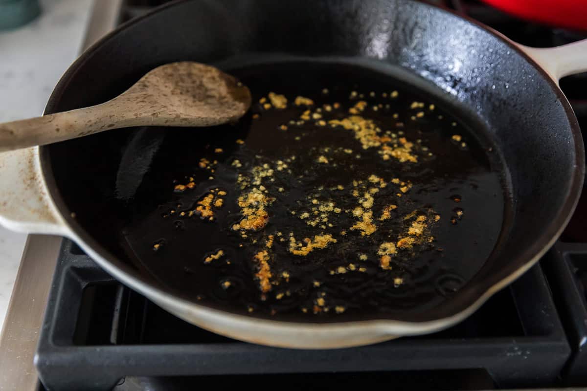 Sauteing garlic in cast iron pan.