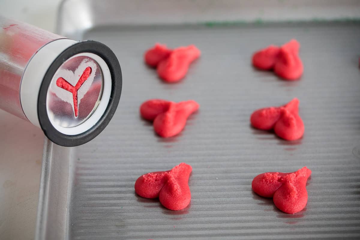 Colored cookie dough pressed onto a baking sheet.