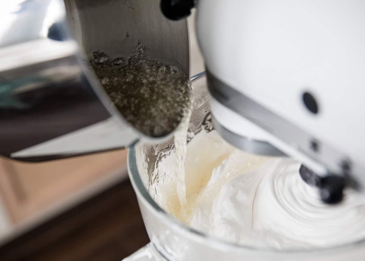 Pouring hot sugar mixture into egg whites.