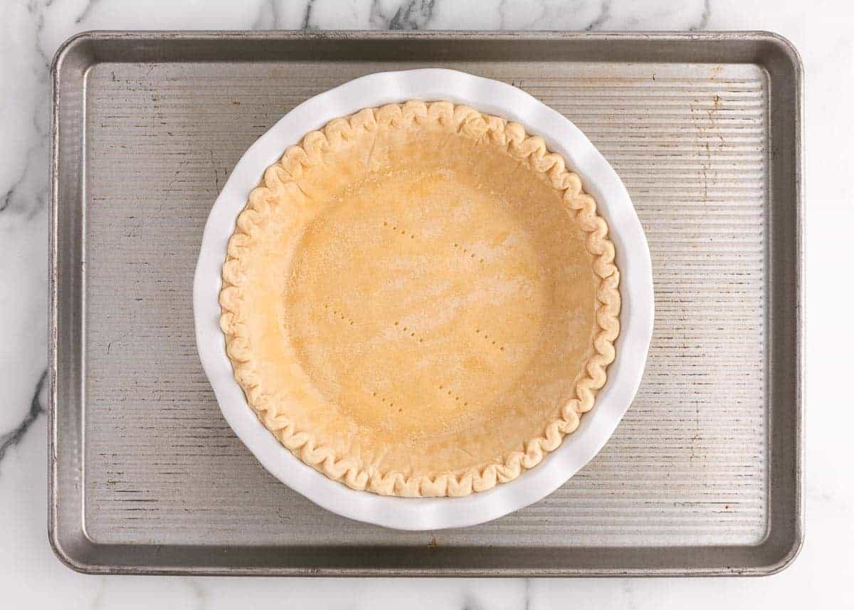 Baked pie crust on baking sheet.