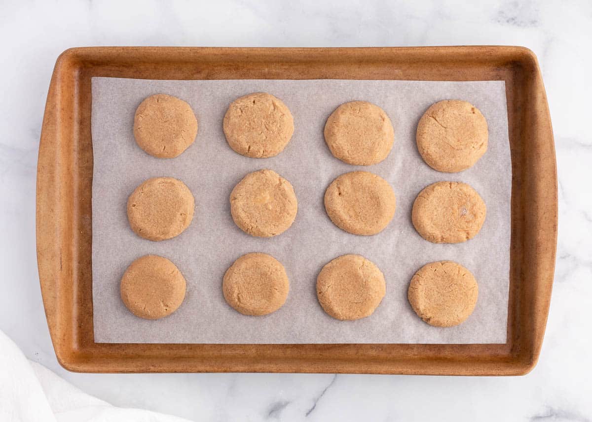 Baked peanut butter cookies ready to be decorated like spiders.