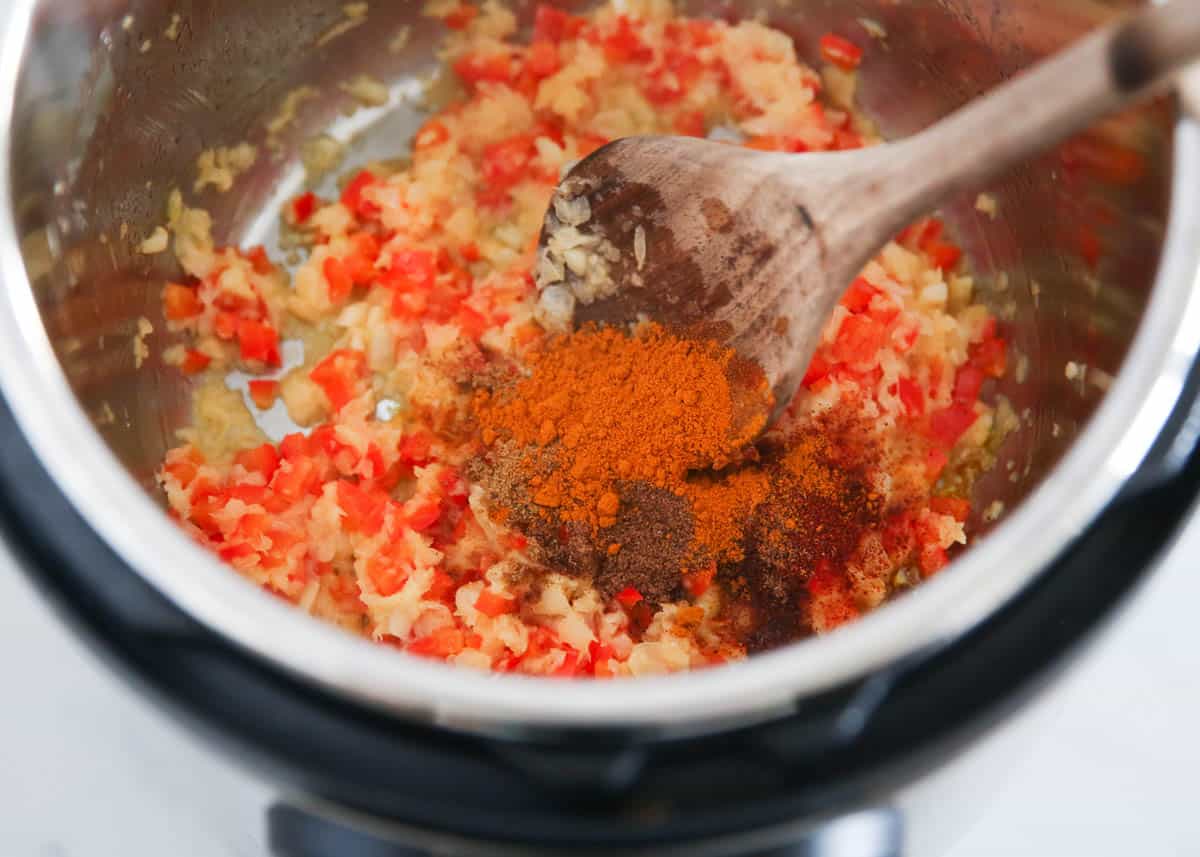 Cooking spices with onions in Instant Pot.