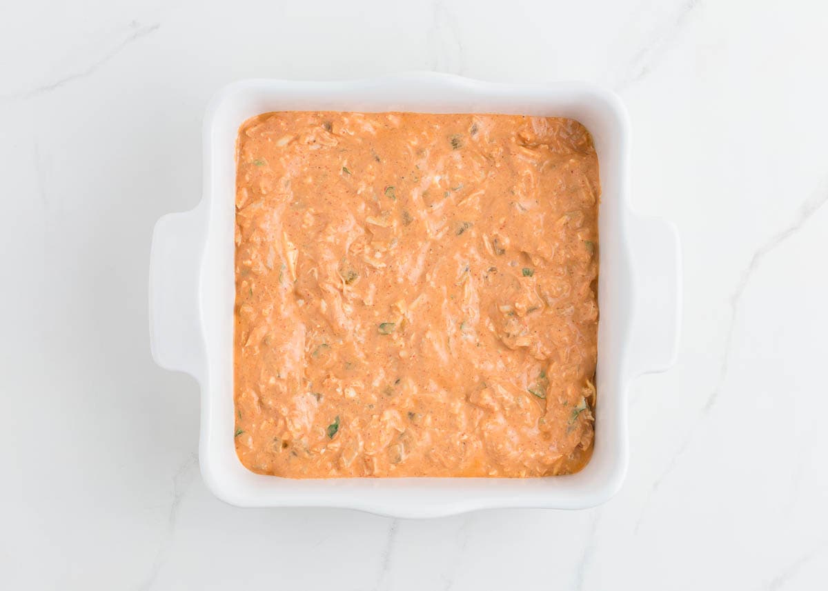 Chicken enchilada dip in baking dish.