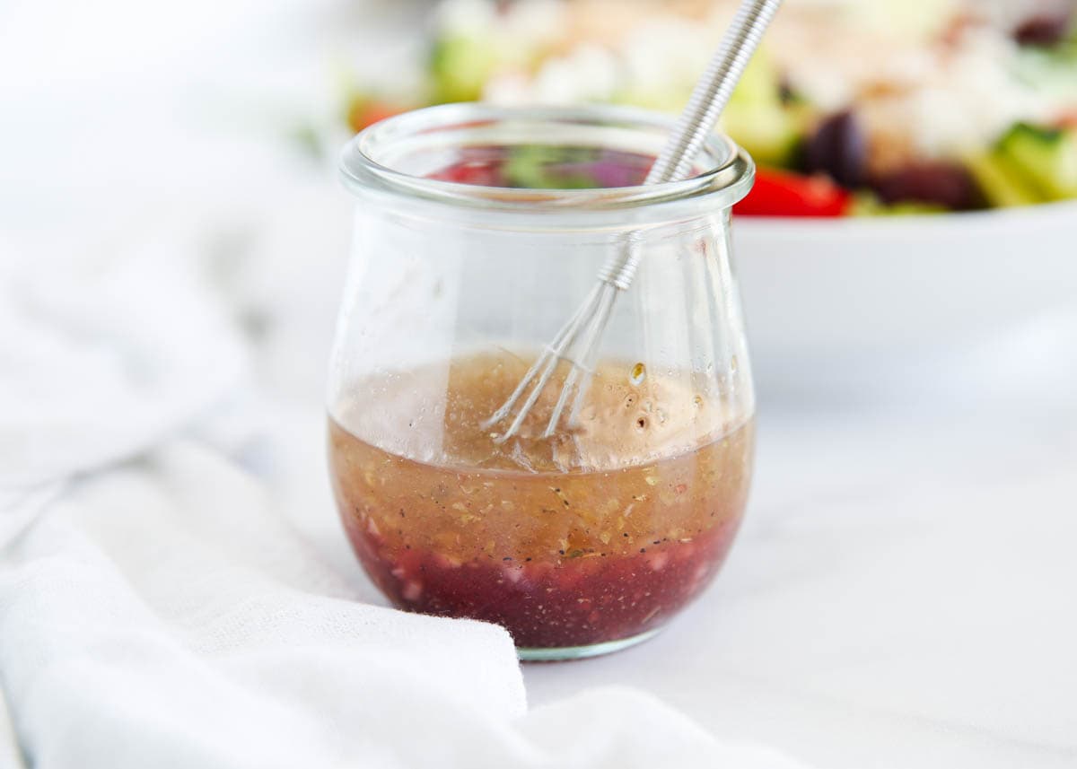 Greek salad dressing in a small jar.