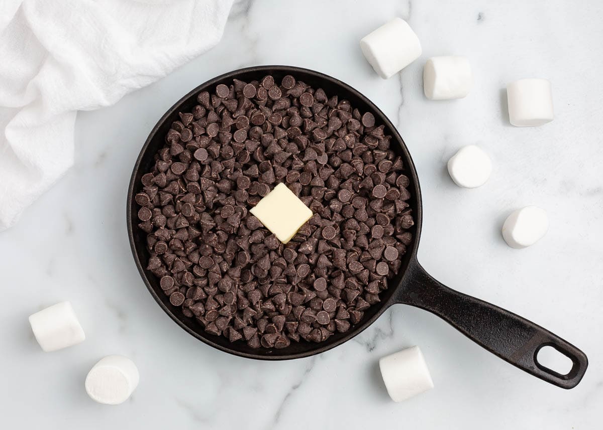 Chocolate chips with butter in a cast iron skillet.