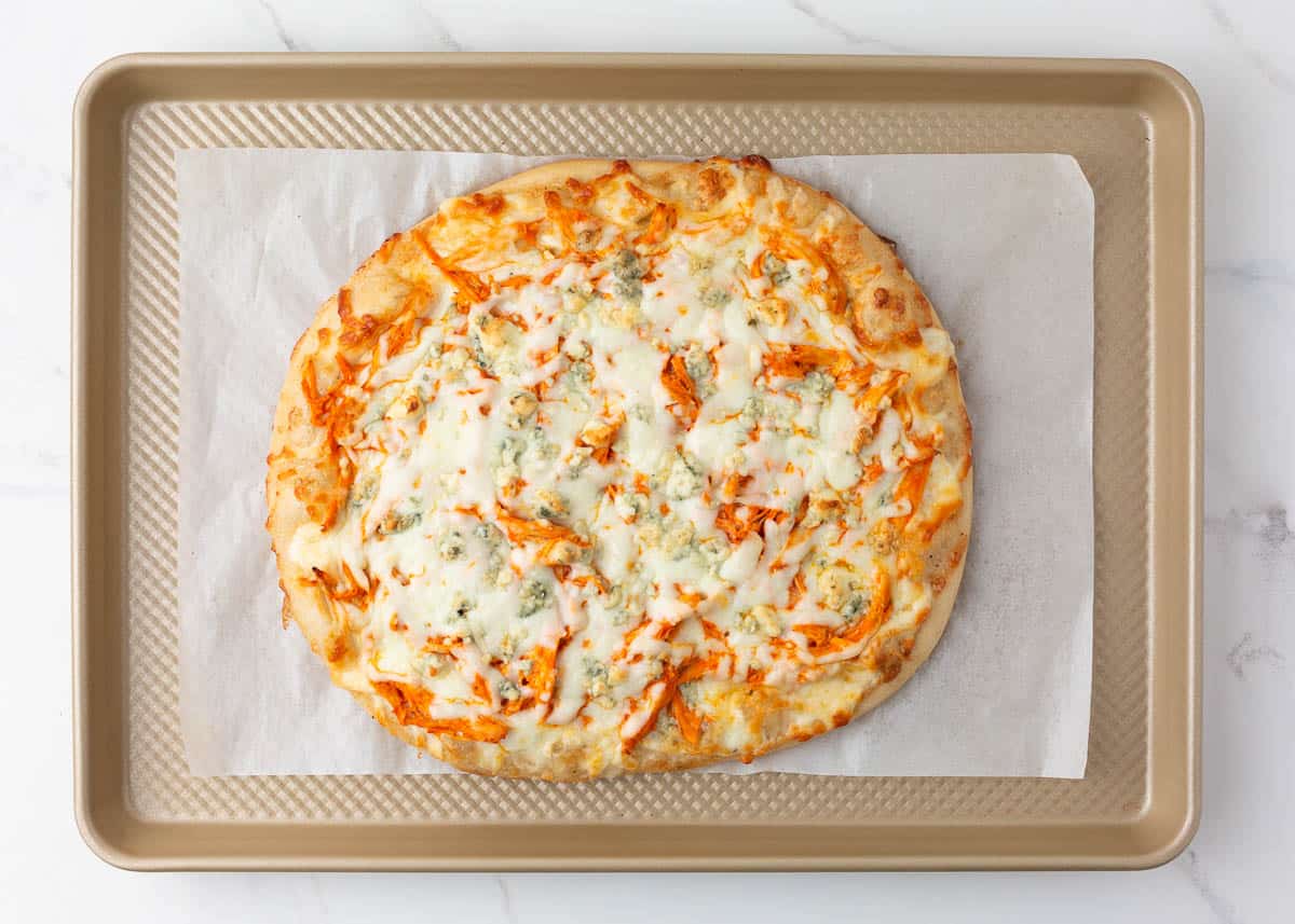 Pizza on baking sheet.