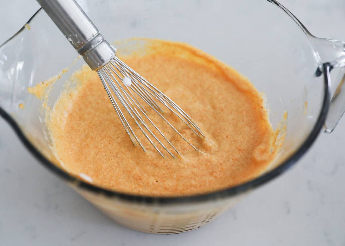 Pumpkin puree, eggs, sugar, butter and vanilla in a bowl with whisk.