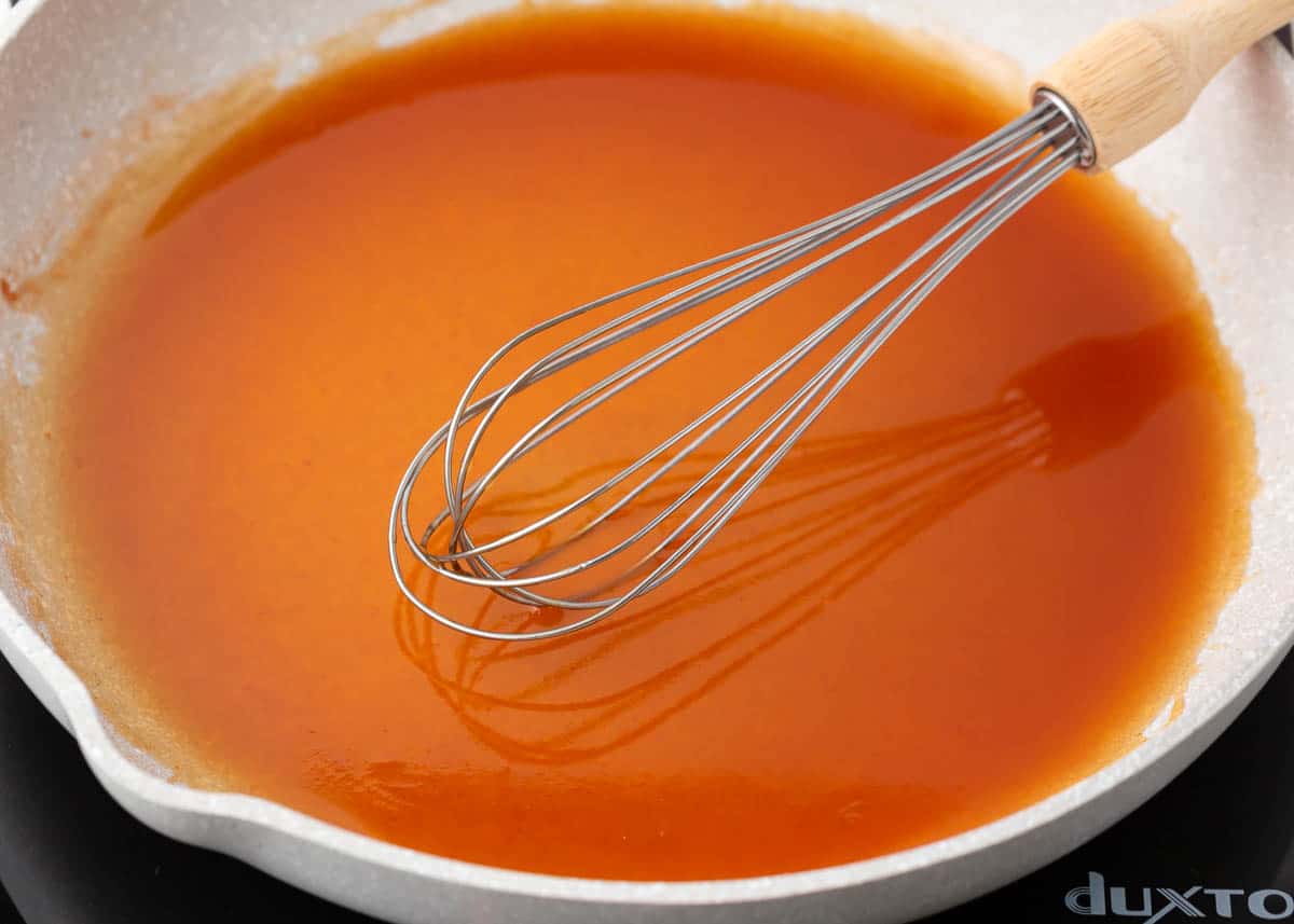 Sweet and sour sauce simmering in a pan.