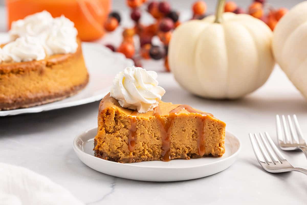 Pumpkin cheesecake with gingersnap crust on a plate.