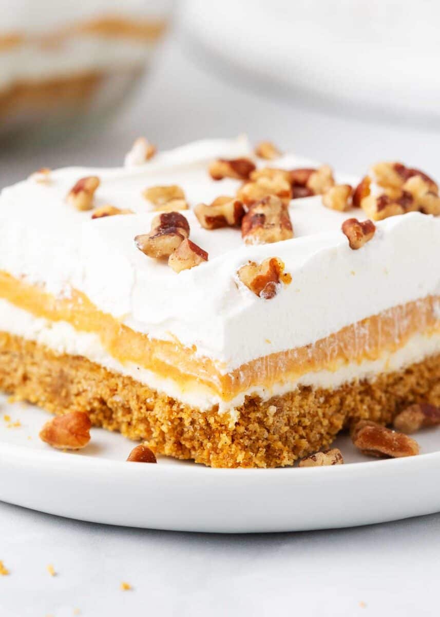 Pumpkin lasagna with pecans on white plate.