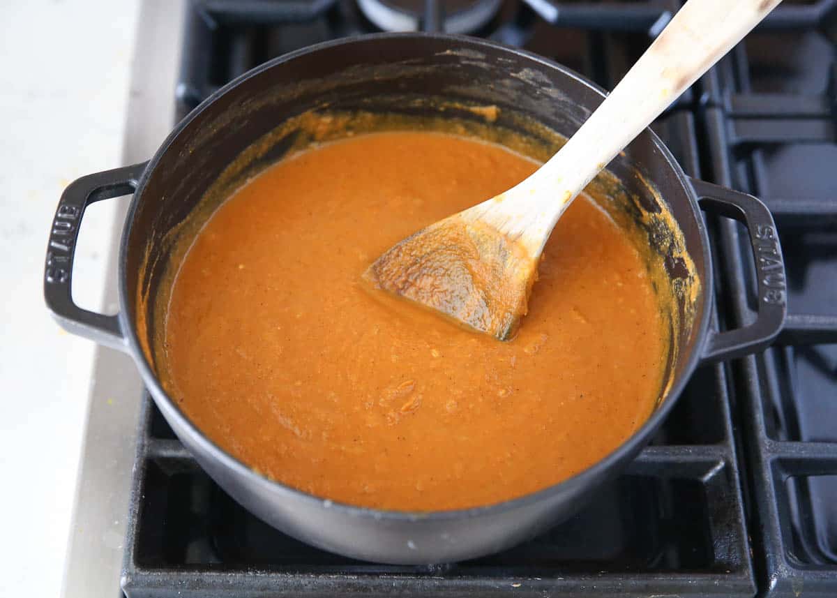 Pumpkin soup in a pot on the stove.