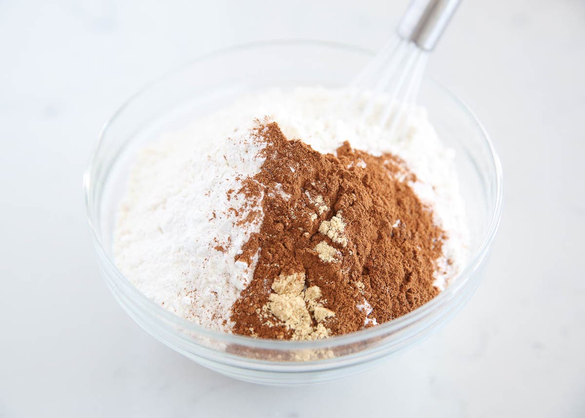 Flour, sugar, cinnamon and pumpkin pie spice in a bowl.