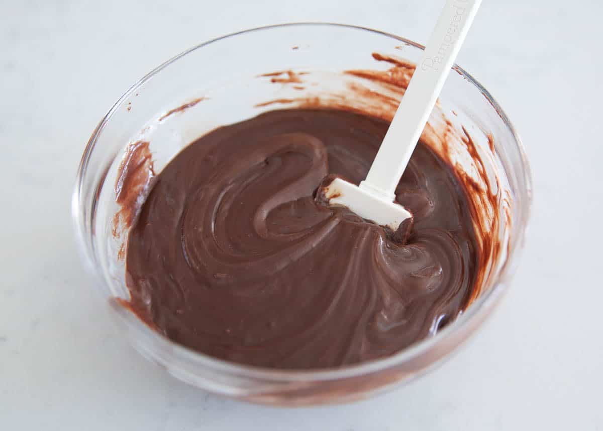 Melted chocolate in a bowl with a spatula.