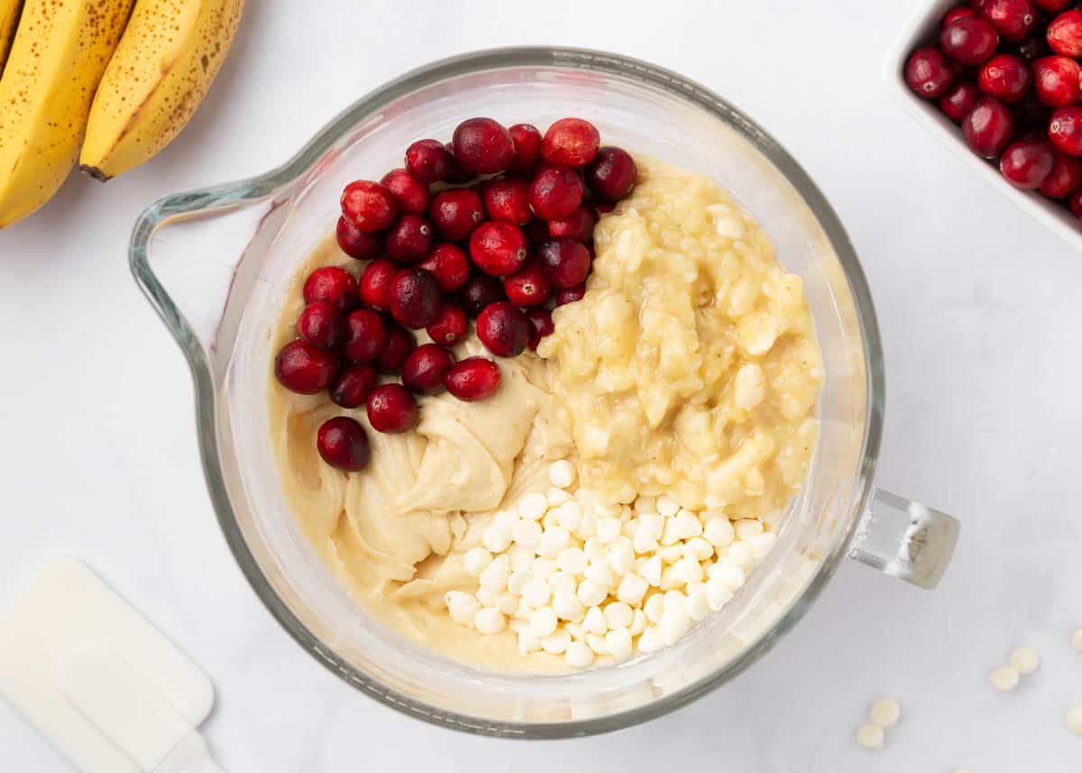 Cranberries, bananas and white chocolate chips in a bowl.