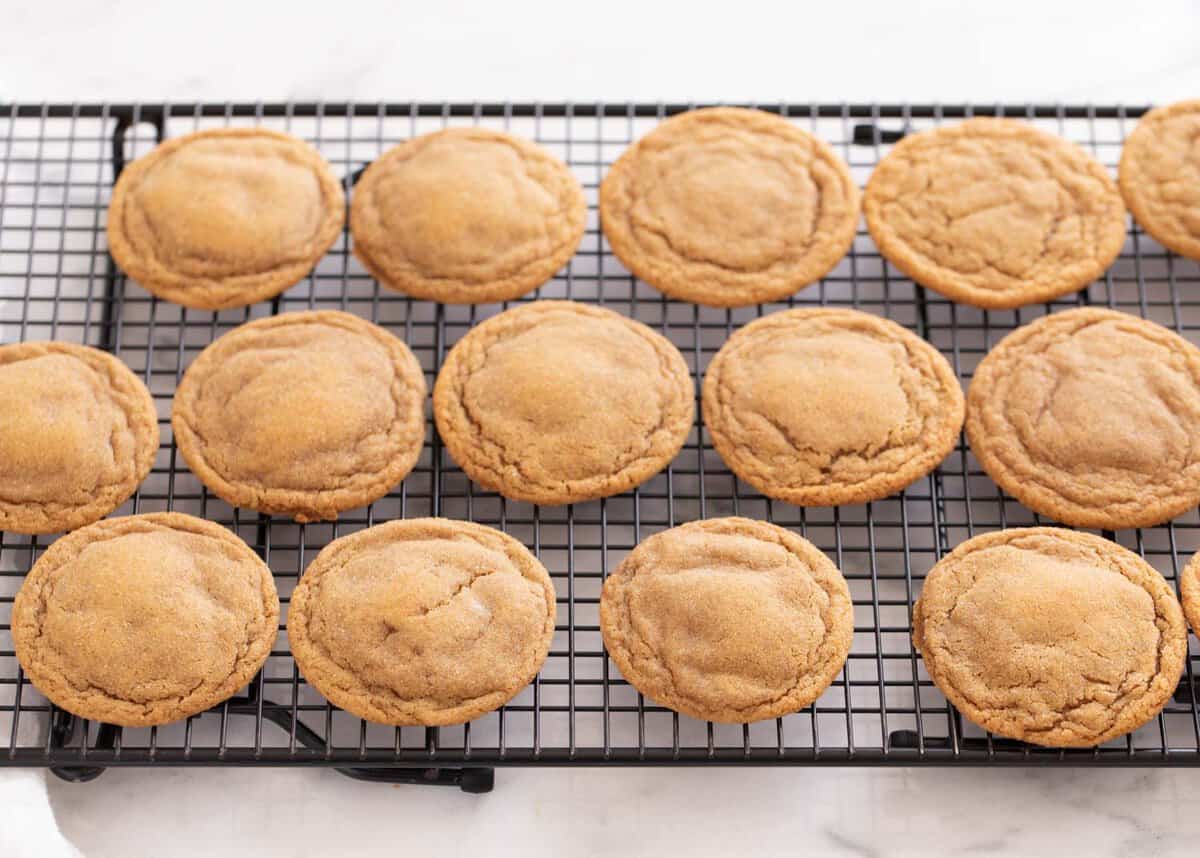 Ginger molasses cookies on a wire cooling rack.