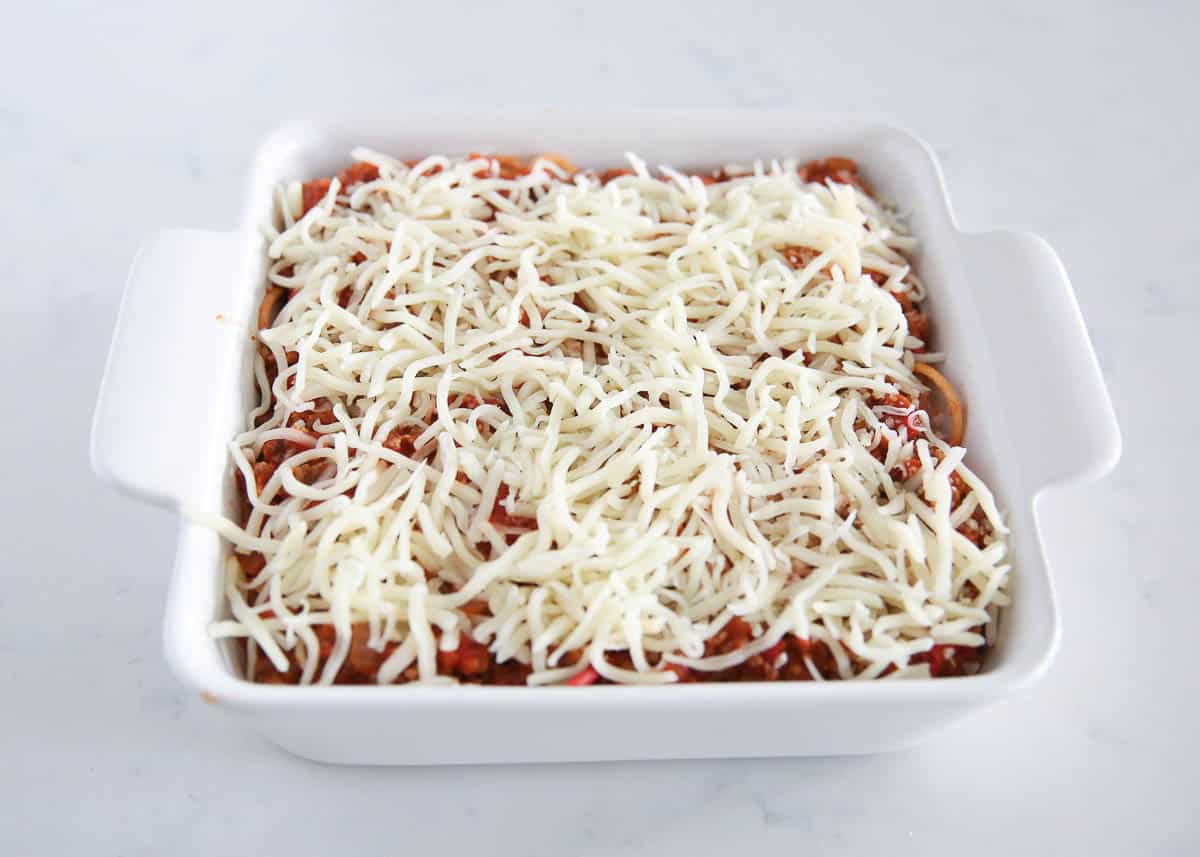 Unbaked million dollar spaghetti casserole in baking dish.