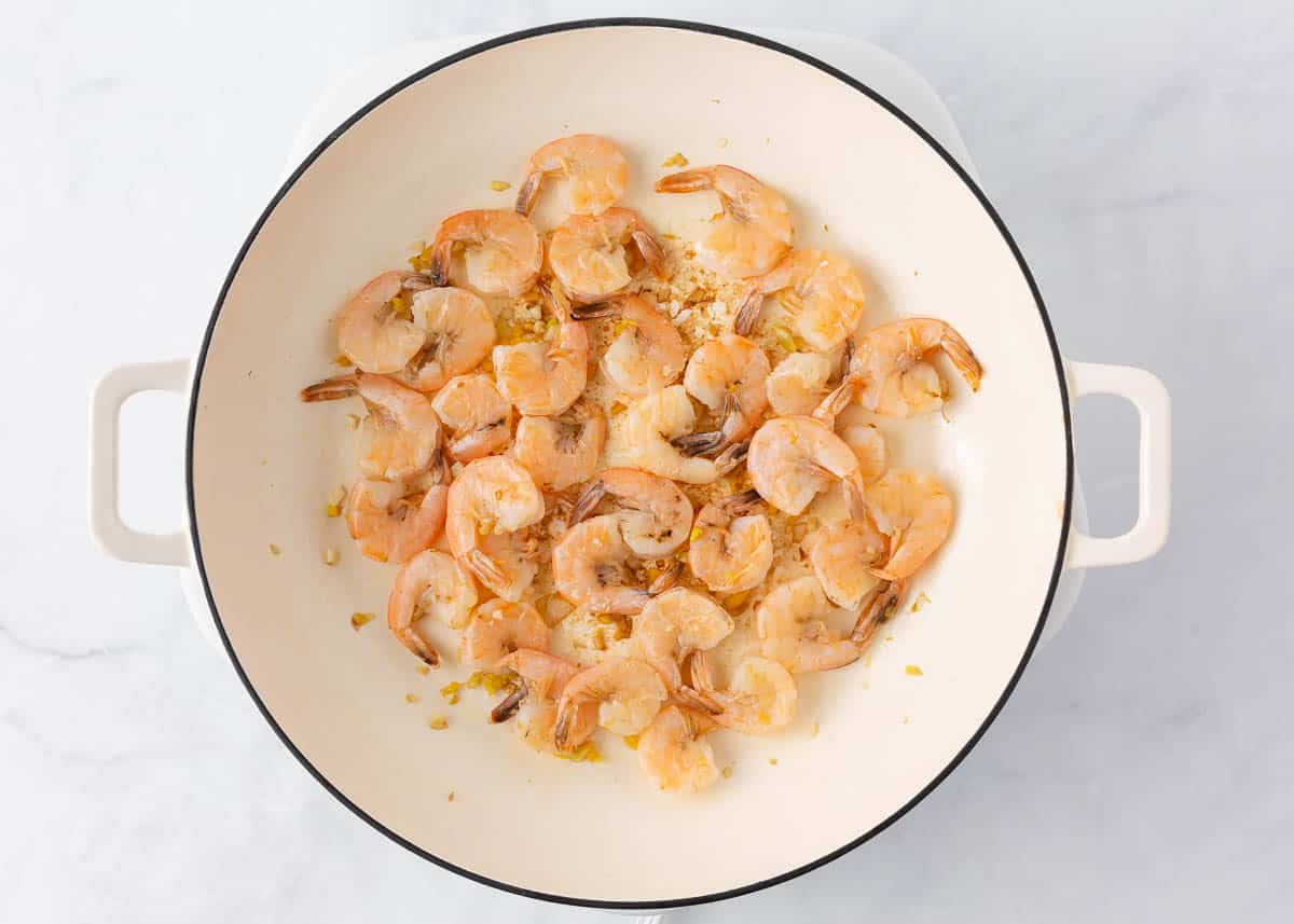 Sauteed shrimp in a skillet.