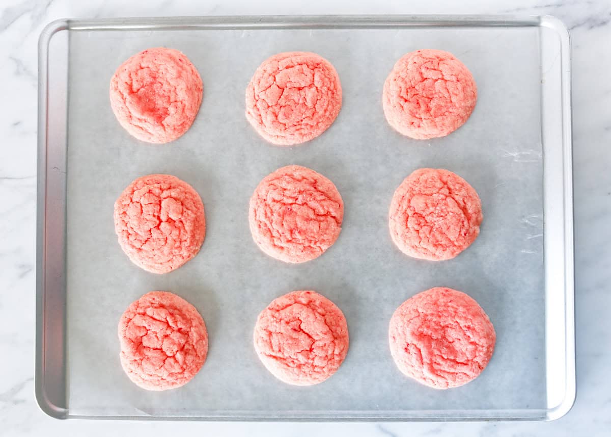 Strawberry cake mix cookies on a baking sheet.