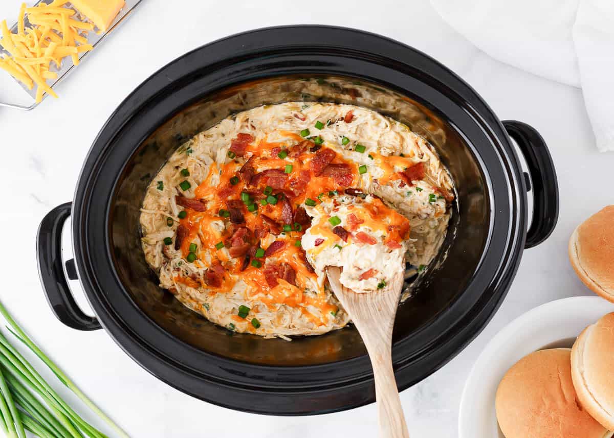 Slow cooker crack chicken in a crockpot with serving spoon.