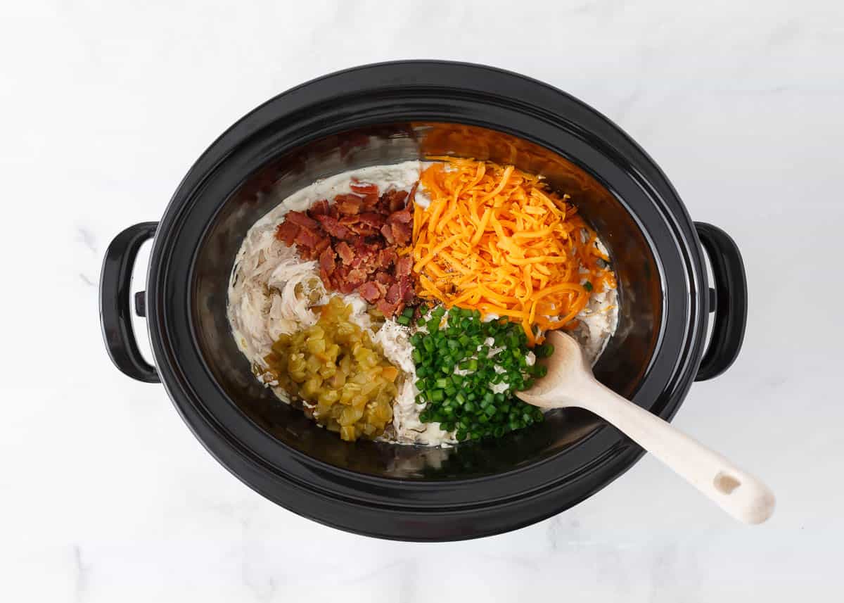 Adding cheese, green chiles and bacon to crockpot crack chicken.