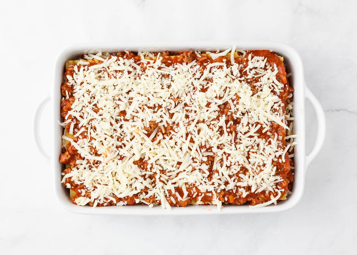 FInal layer of mozzarella cheese in a baking dish.