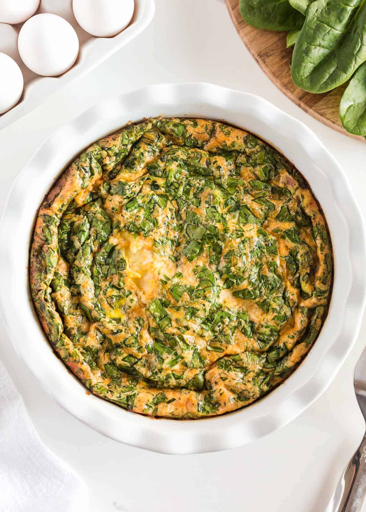 Crustless quiche in a white baking dish.