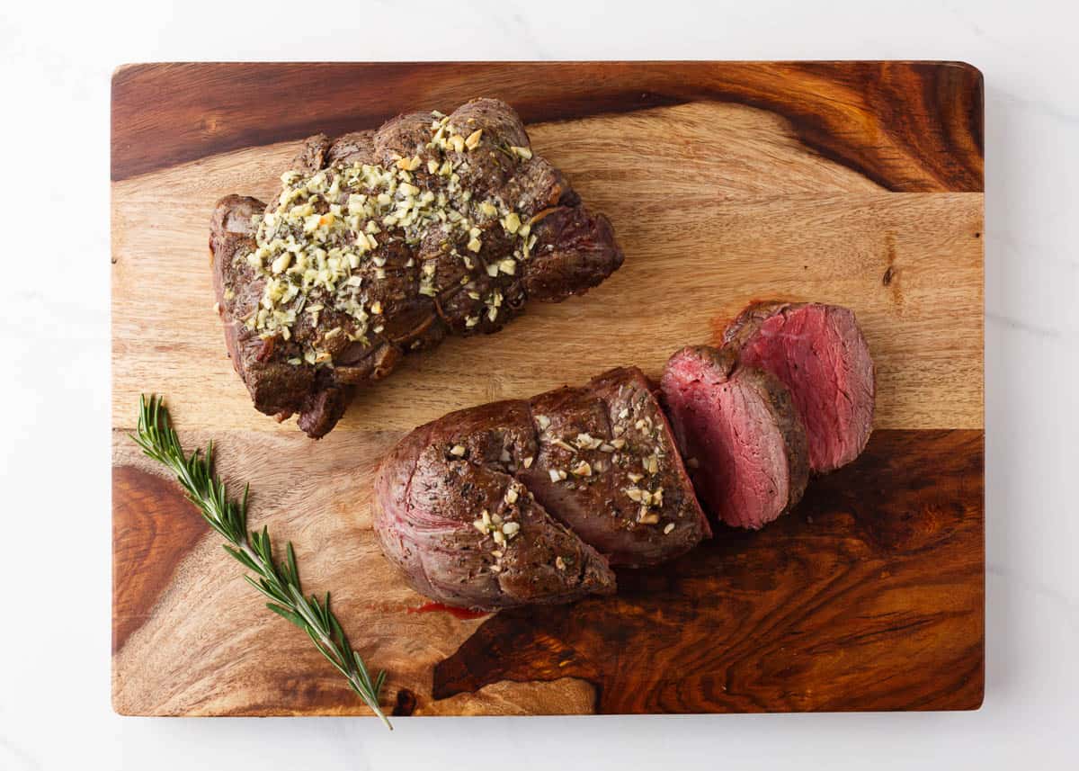 Beef tenderloin on a cutting board.