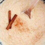 Arroz con leche in pot with cinnamon sticks.