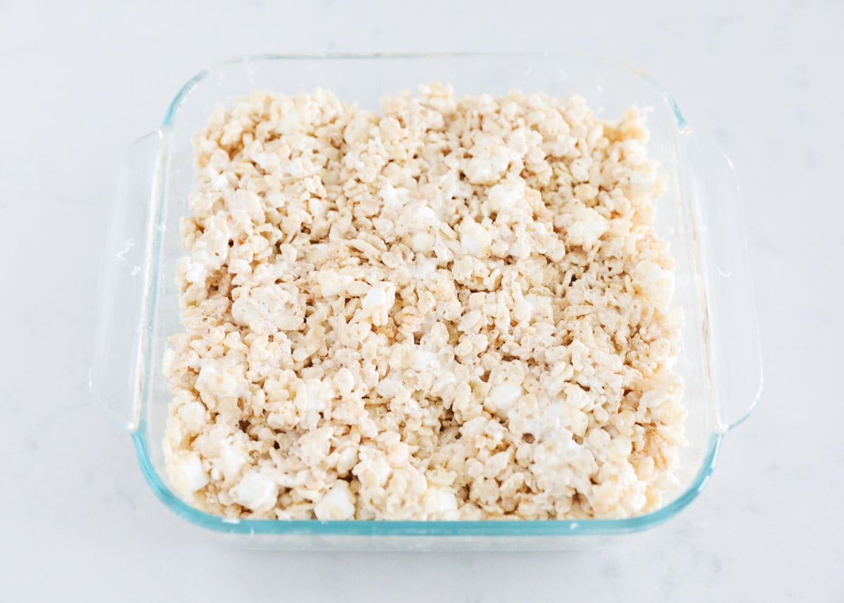 Brown butter rice krispie treats in a clear baking dish.