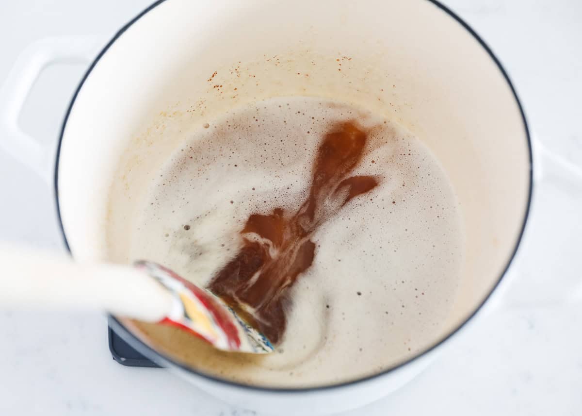 Making brown butter in a white pot.