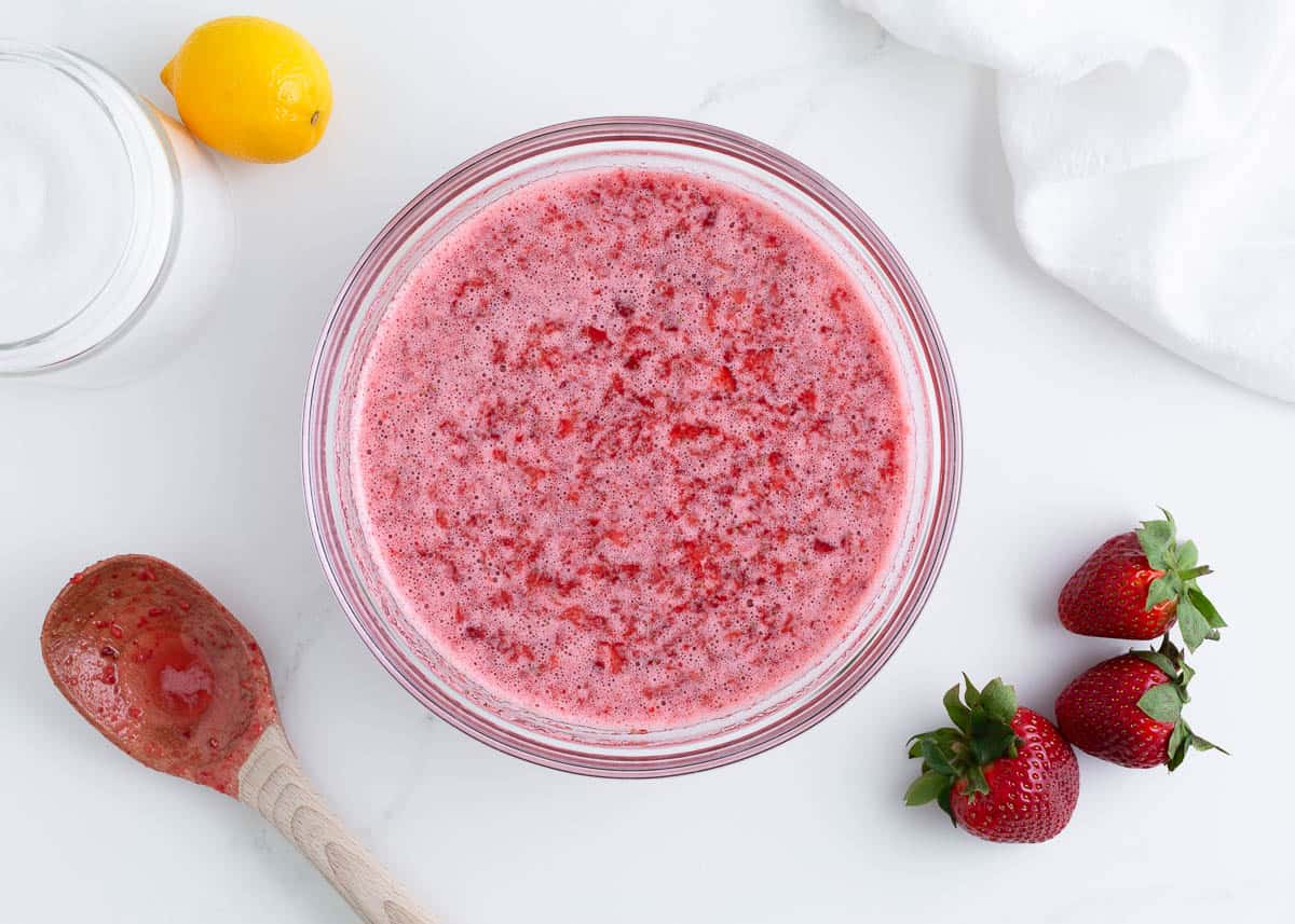 Strawberries and sugar in a bowl.