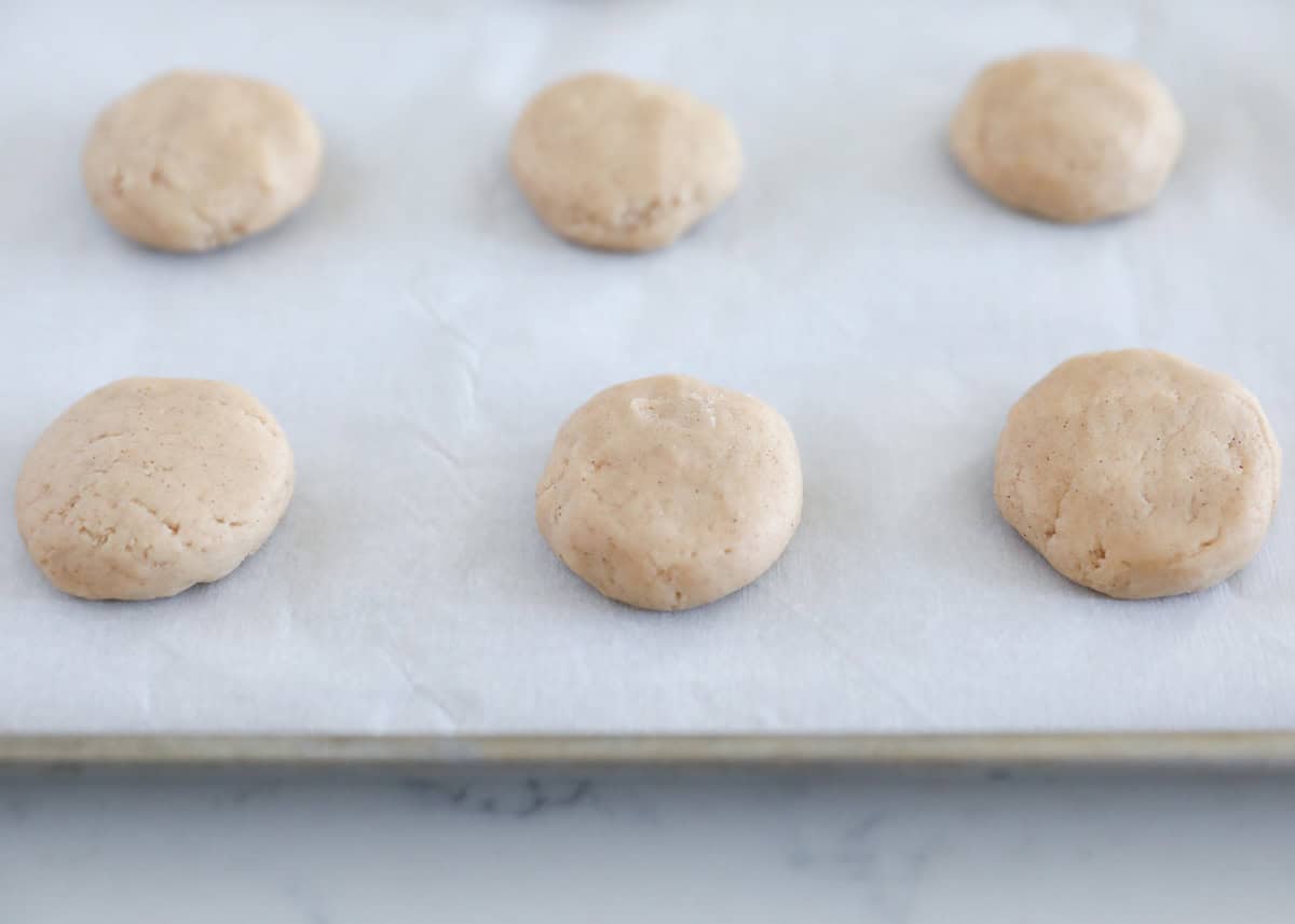 Unbaked cinnamon roll cookies on a baking sheet.