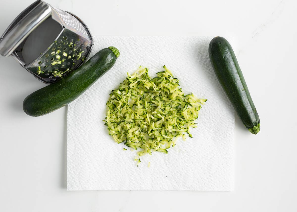 Shredded zucchini on paper towel.