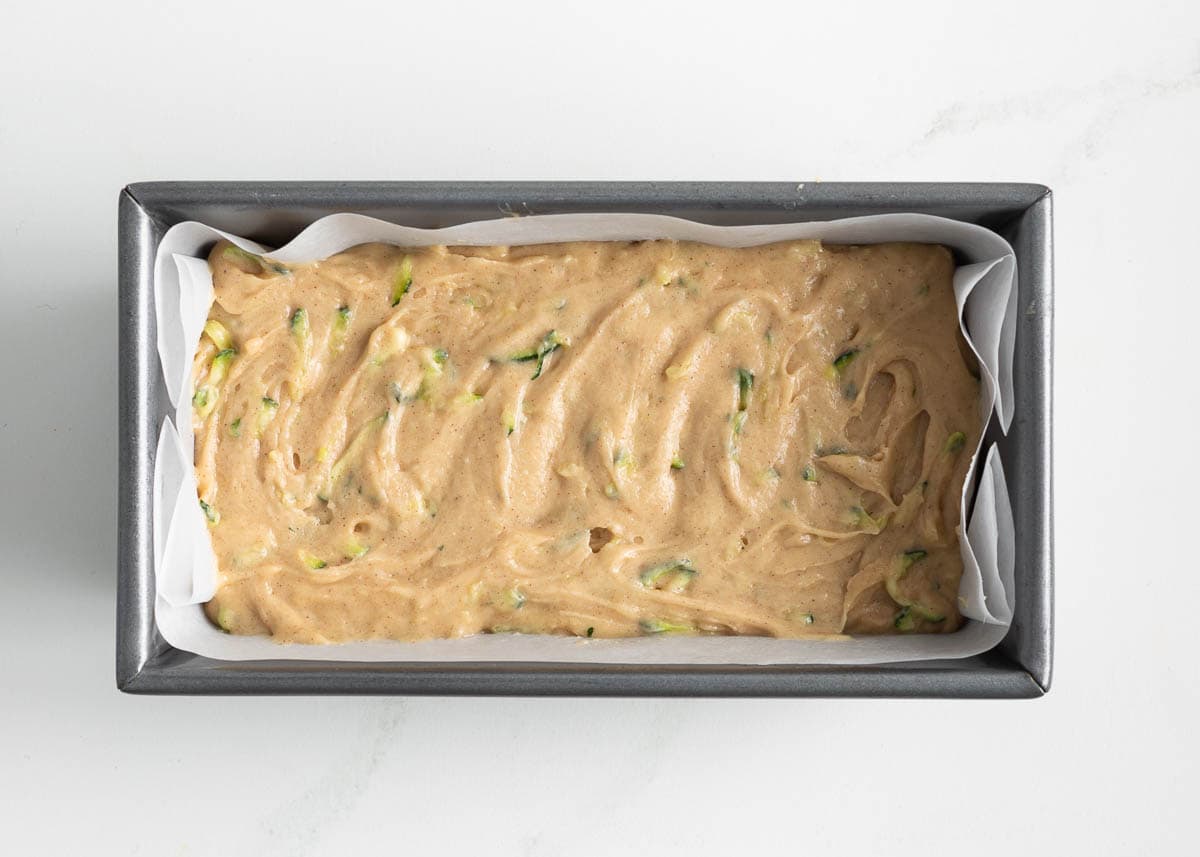 Zucchini bread batter in a loaf pan.