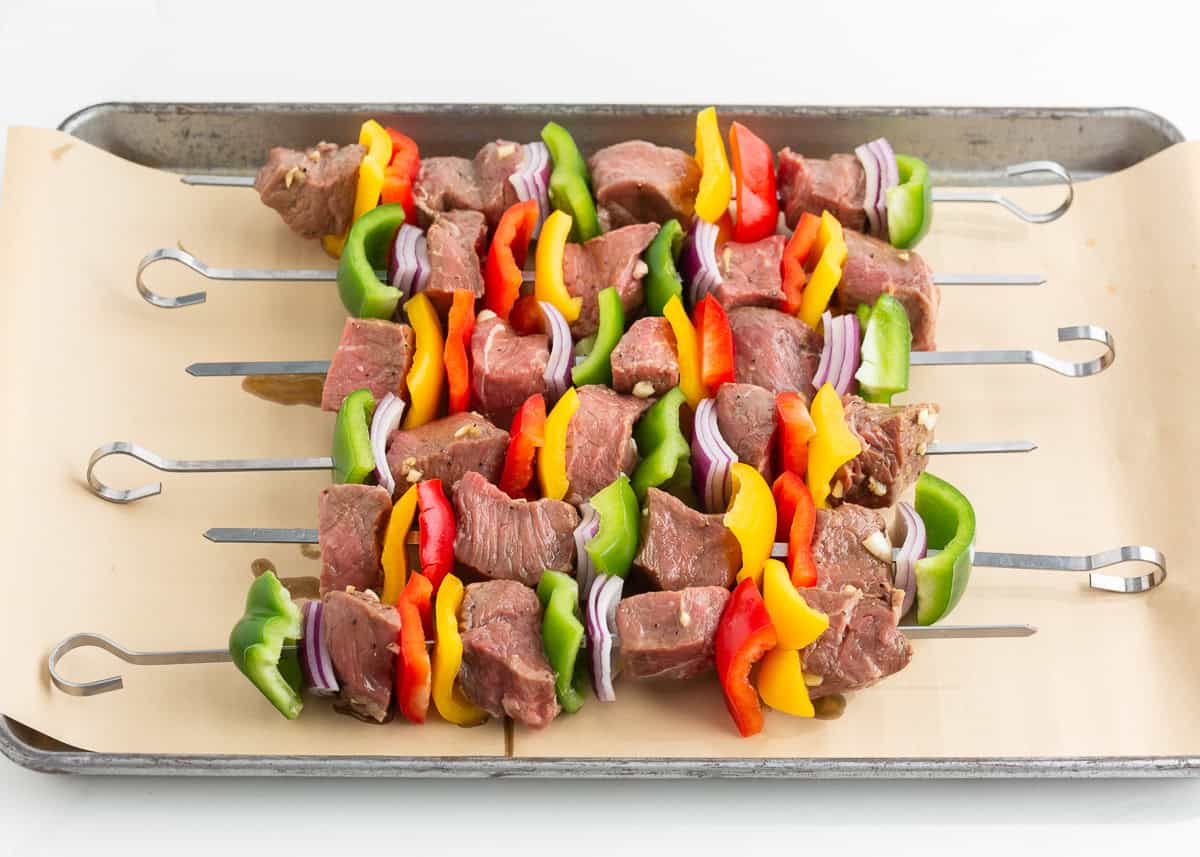 Steak kabobs threaded onto skewers.