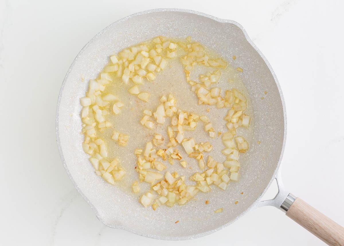 Sauteed onions in a skillet.