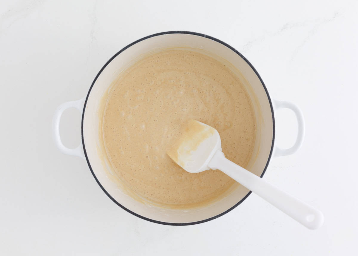 Peanut butter, butter and marshmallows melted and stirred together in a pot.