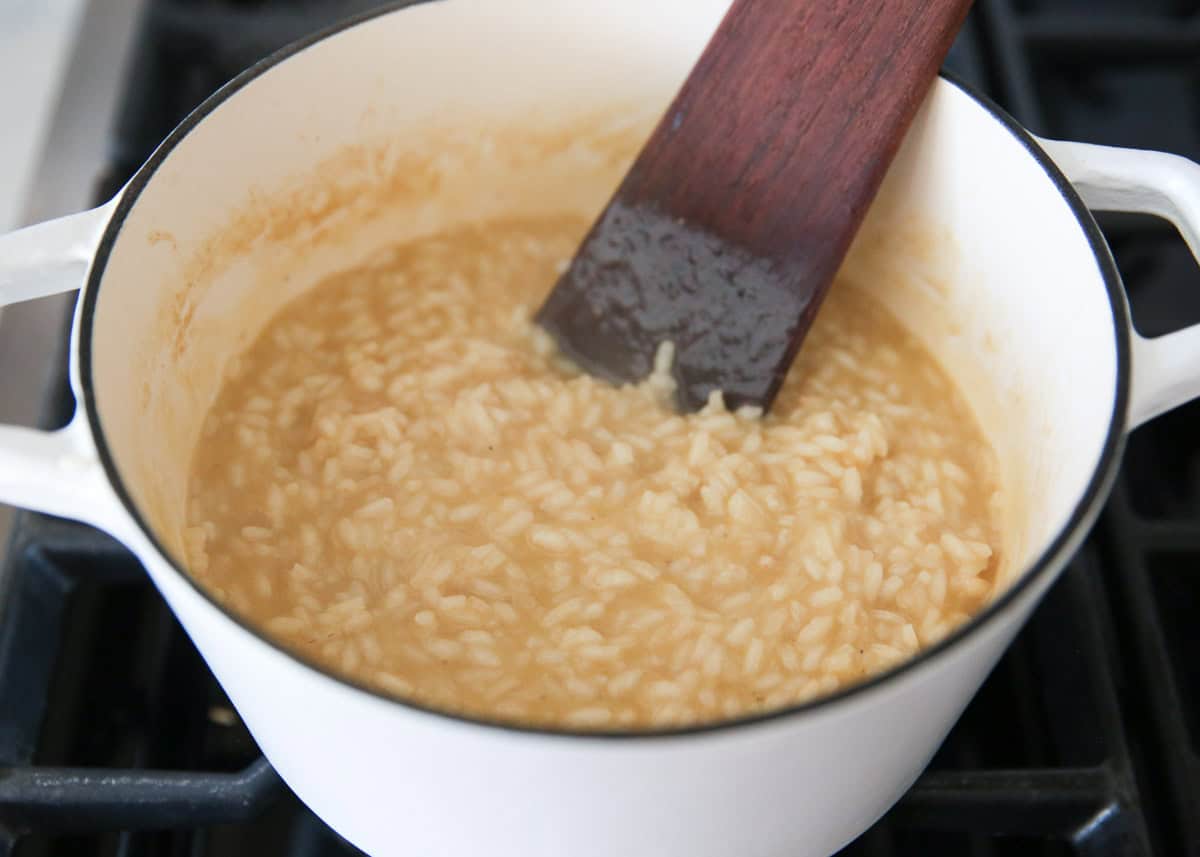 Stirring in broth to risotto.