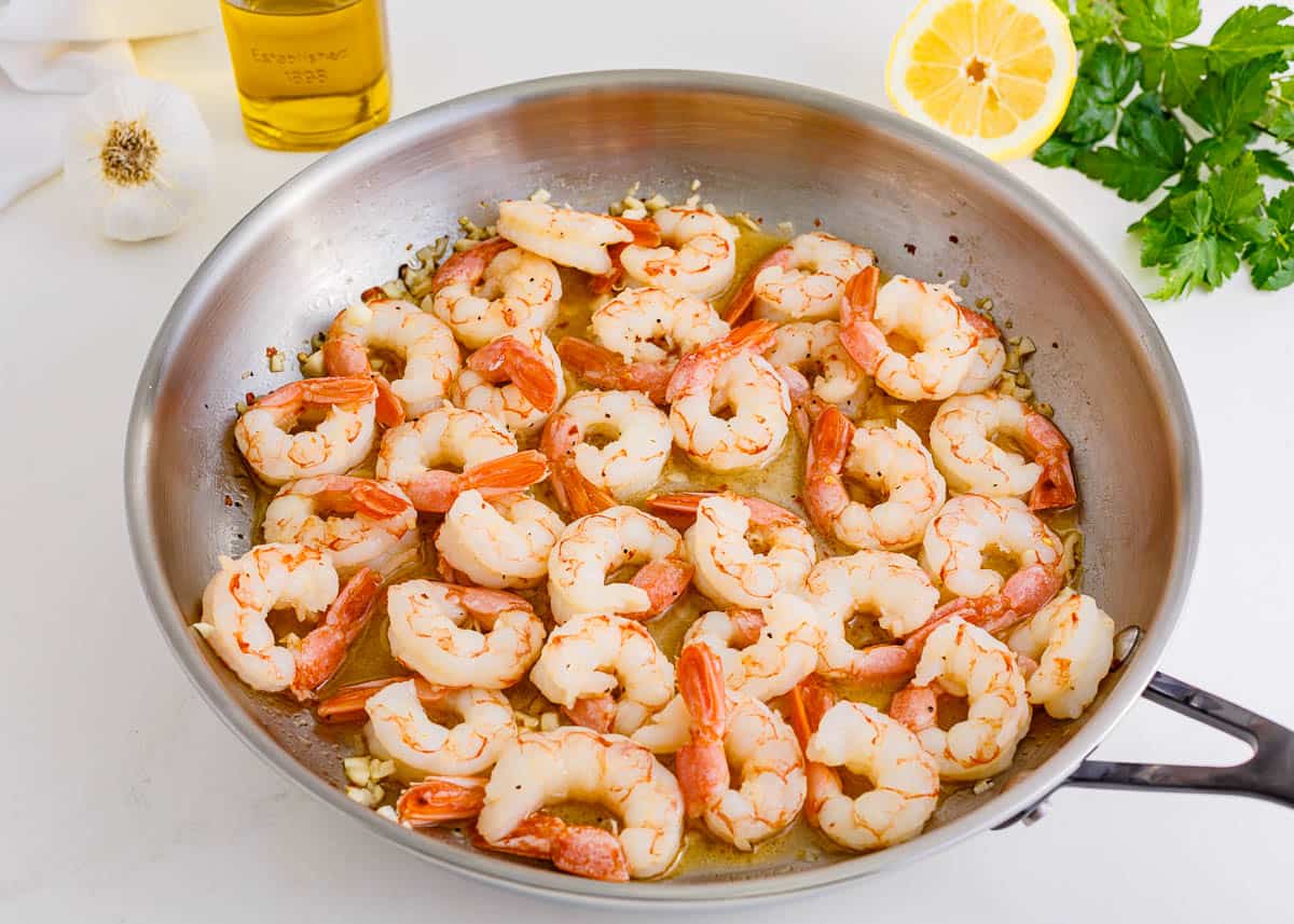 Shrimp in a skillet with garlic butter sauce.