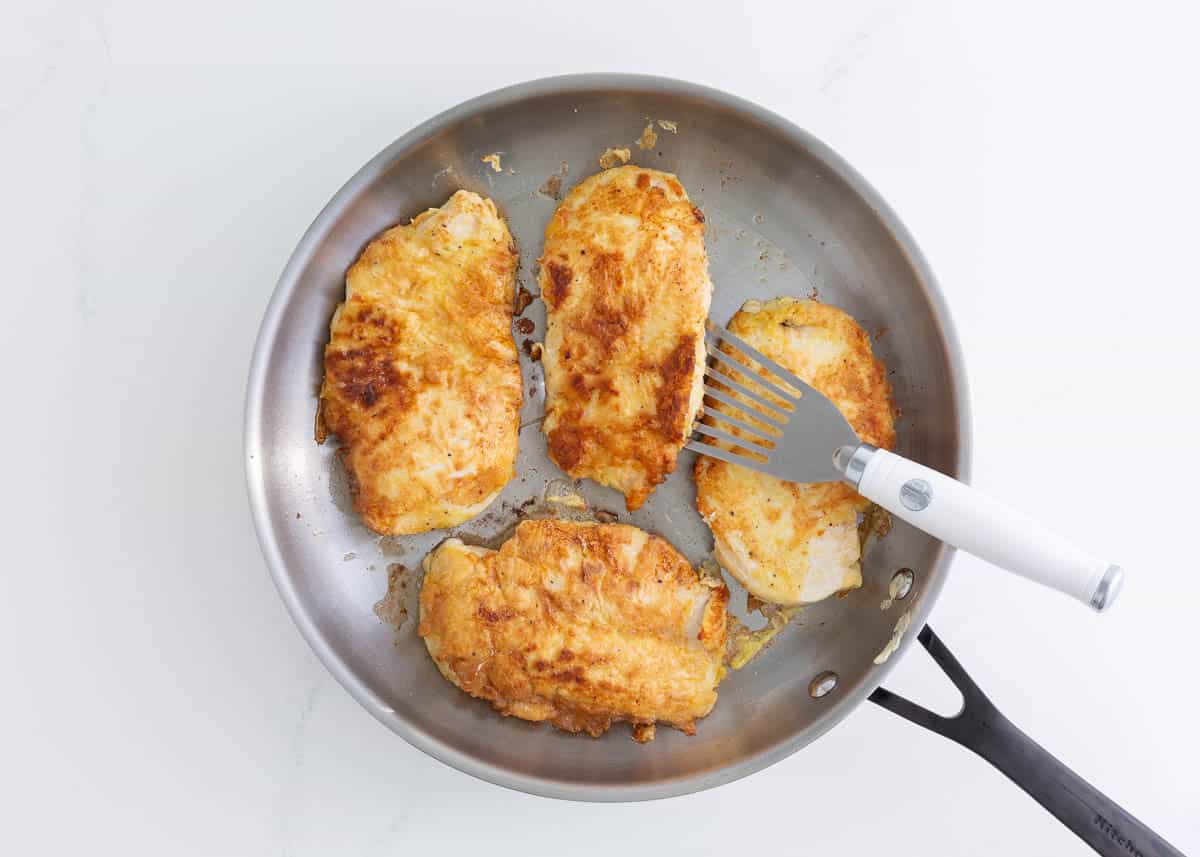 Pan fried chicken in a skillet.