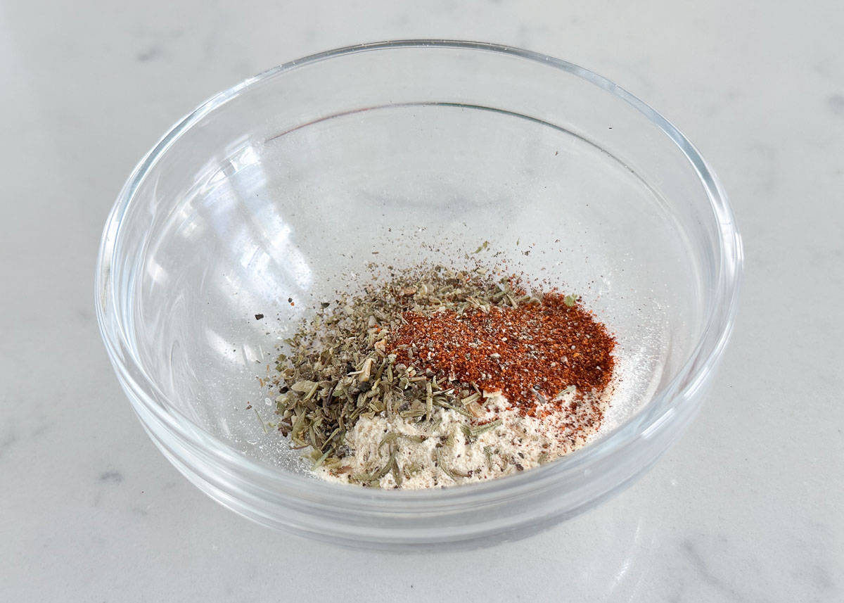 Seasonings for baked chicken thighs in a small bowl.