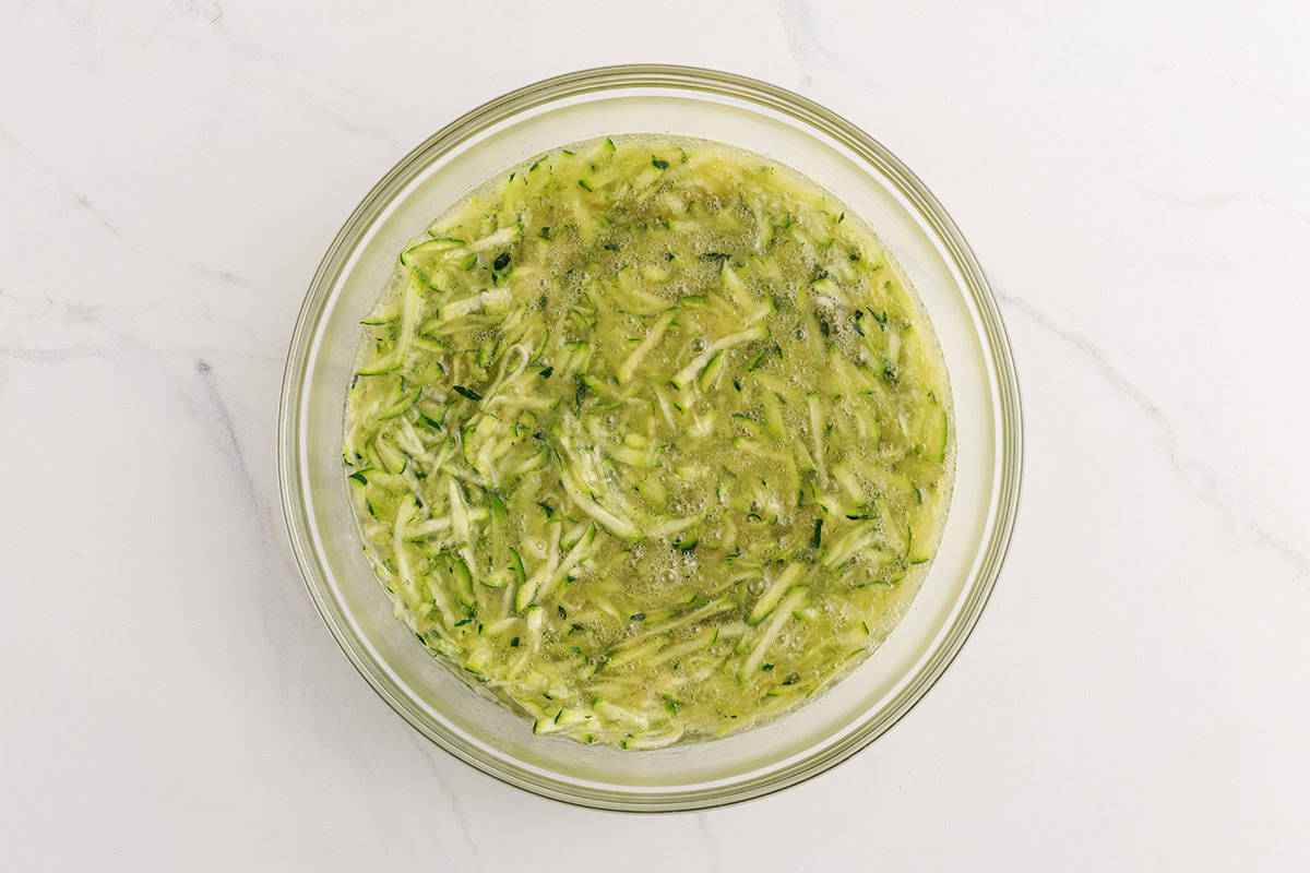 Shredded zucchini in a bowl.