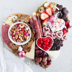 Valentine charcuterie board on marble counter.