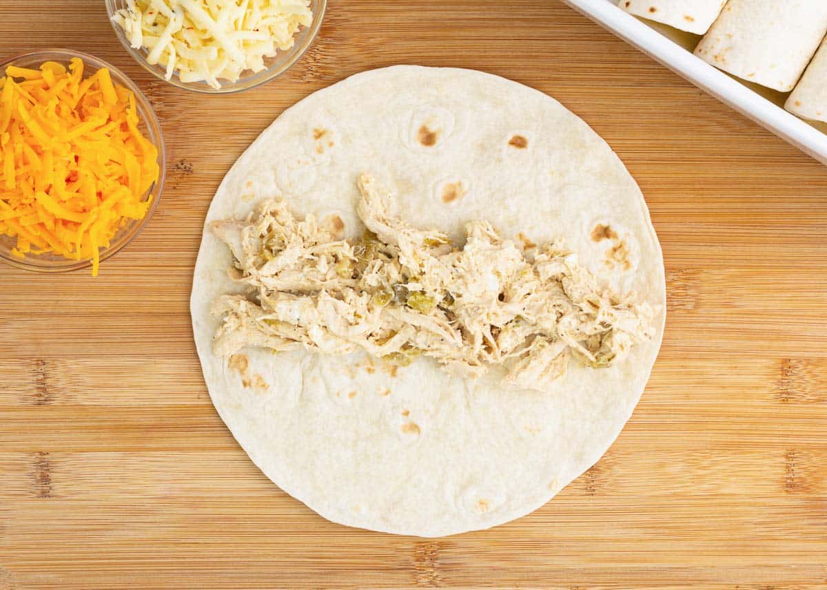 Green chile chicken mixture in tortilla.