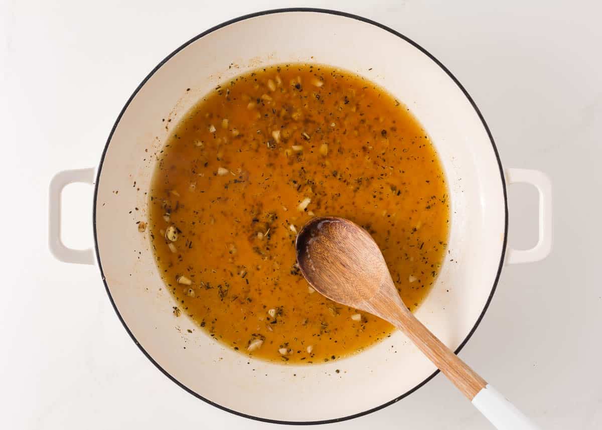 Sauteing garlic and broth.