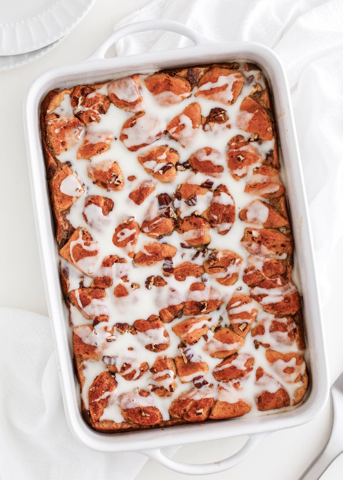 Cinnamon roll casserole in white baking dish.