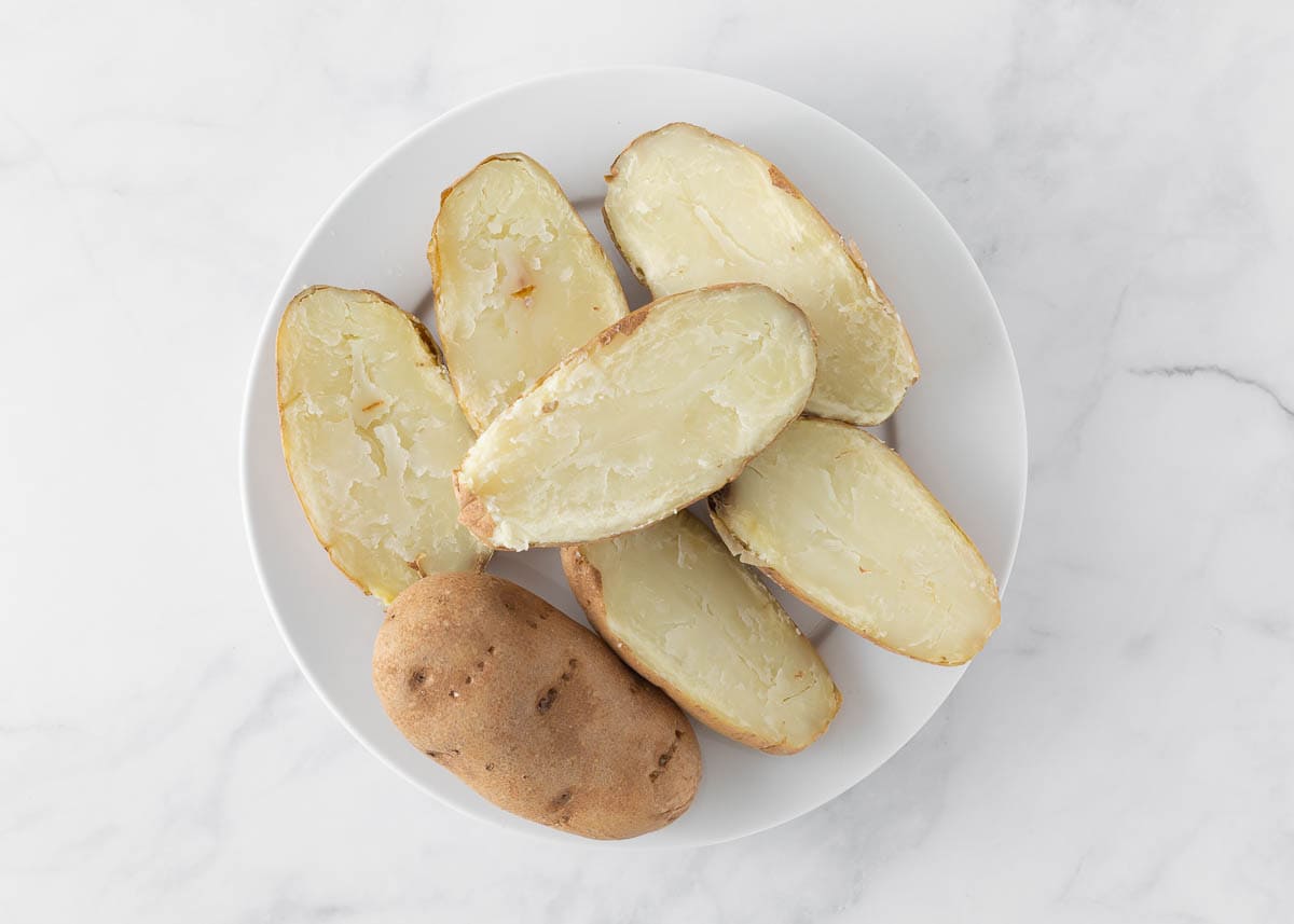 Baked potatoes on a white plate.